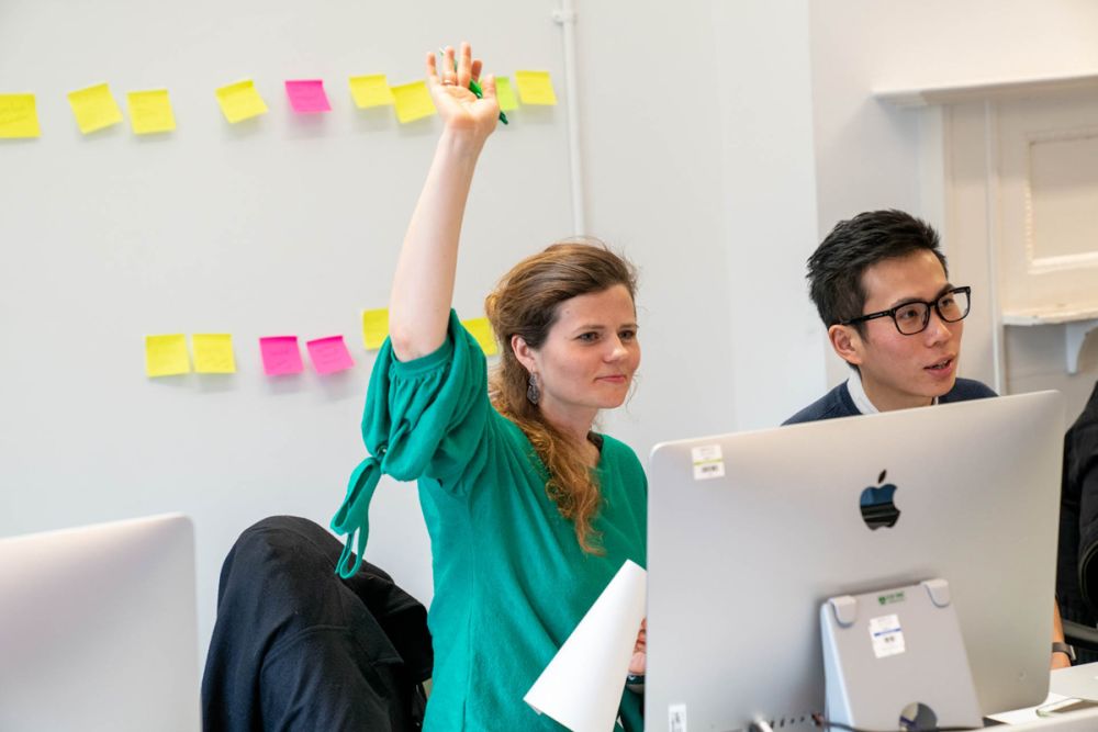 Student raising hand in class.
