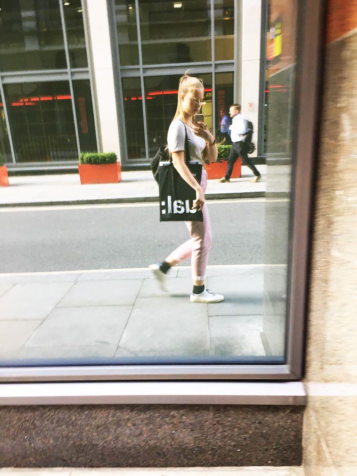 Mandula Pap in London street - reflected in window.