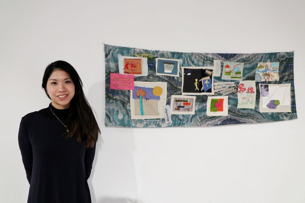 Artists in front of her artwork