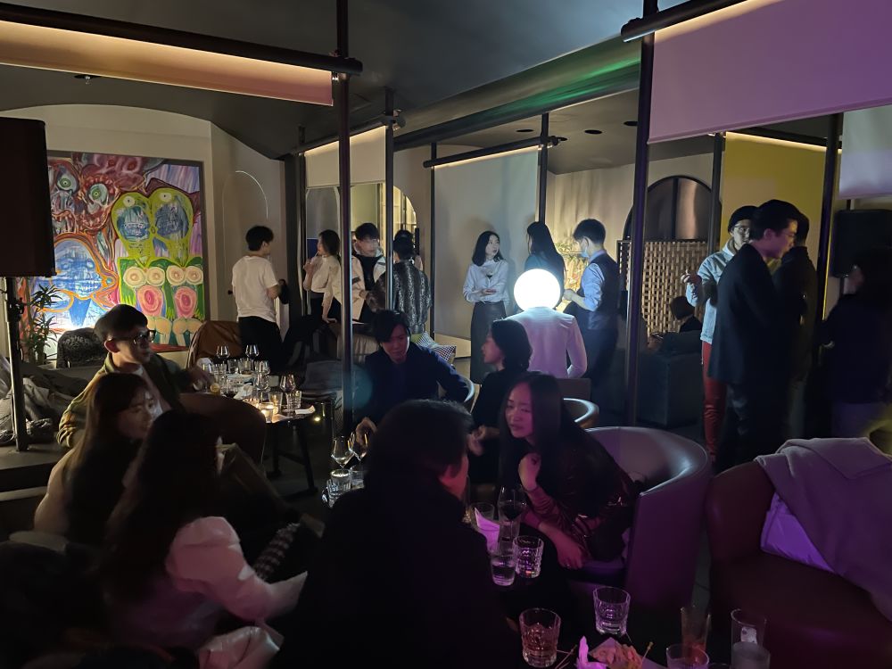 Group of people chatting and drinking together