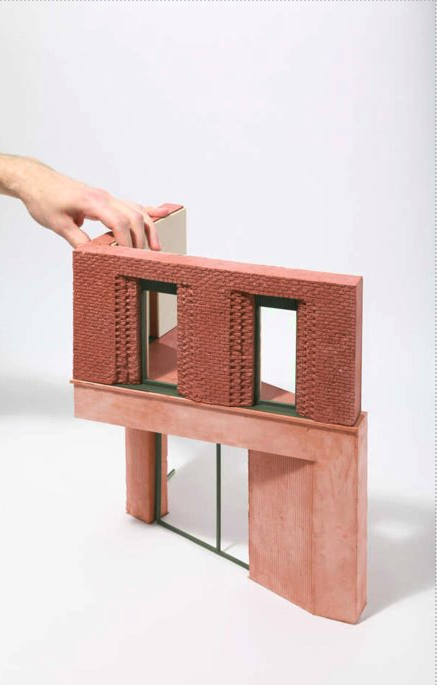 a building scaled down model in plaster, which used a 3d printed model to create a cast