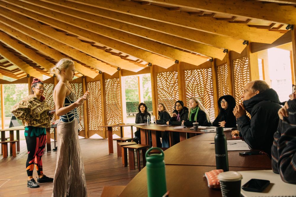 Model and facilitator liaising with students