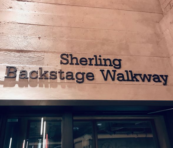 A photograph of a sign 'Sherling Backsatge Walkway'