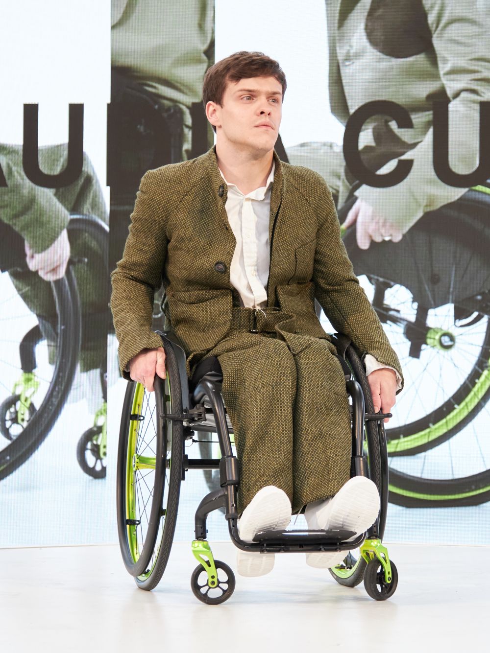 Model wearing suit in wheelchair