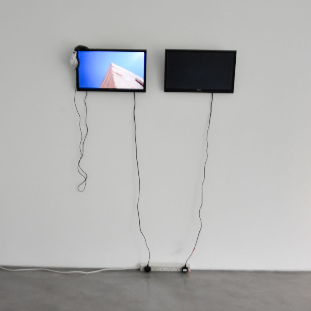 two tv screens in a gallery