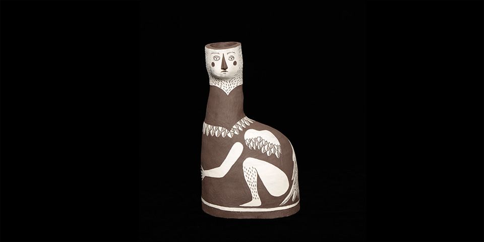 A ceramic vase which depicts a mythological bird figure
