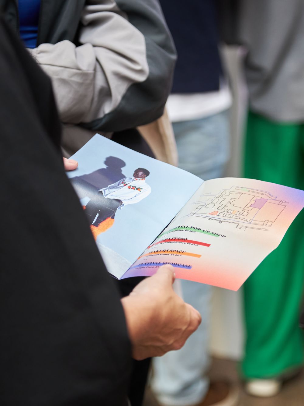 Close up of person's hands holding a booklet