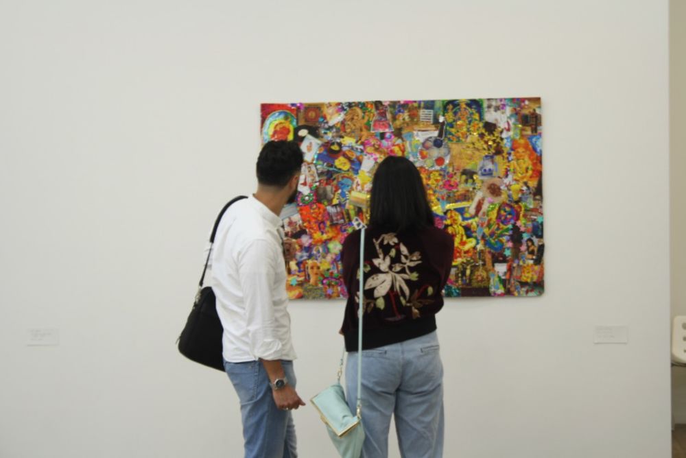 people looking at a painting