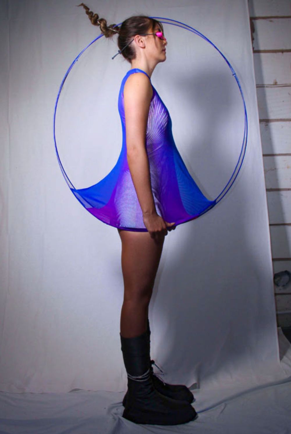 Woman wearing purple dress with circular frame