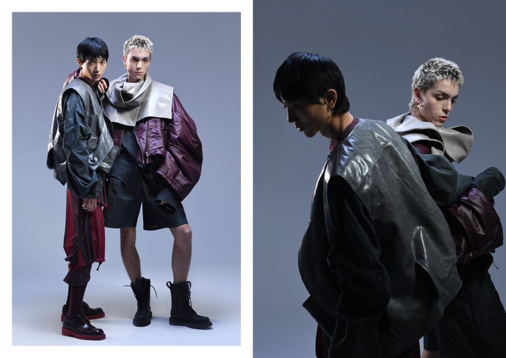Two male models in oversized jackets, shorts and boots.