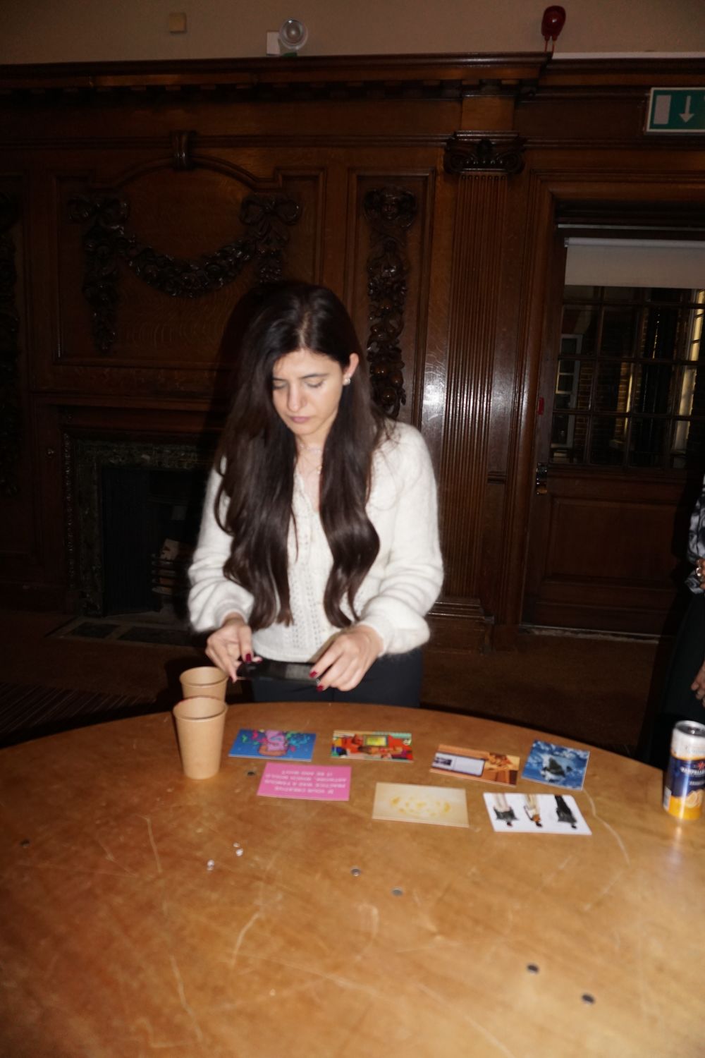 a student looking at cards by a table