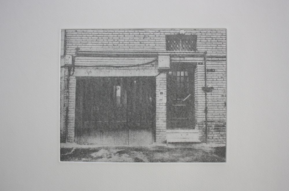 An etching of the front of a brick building