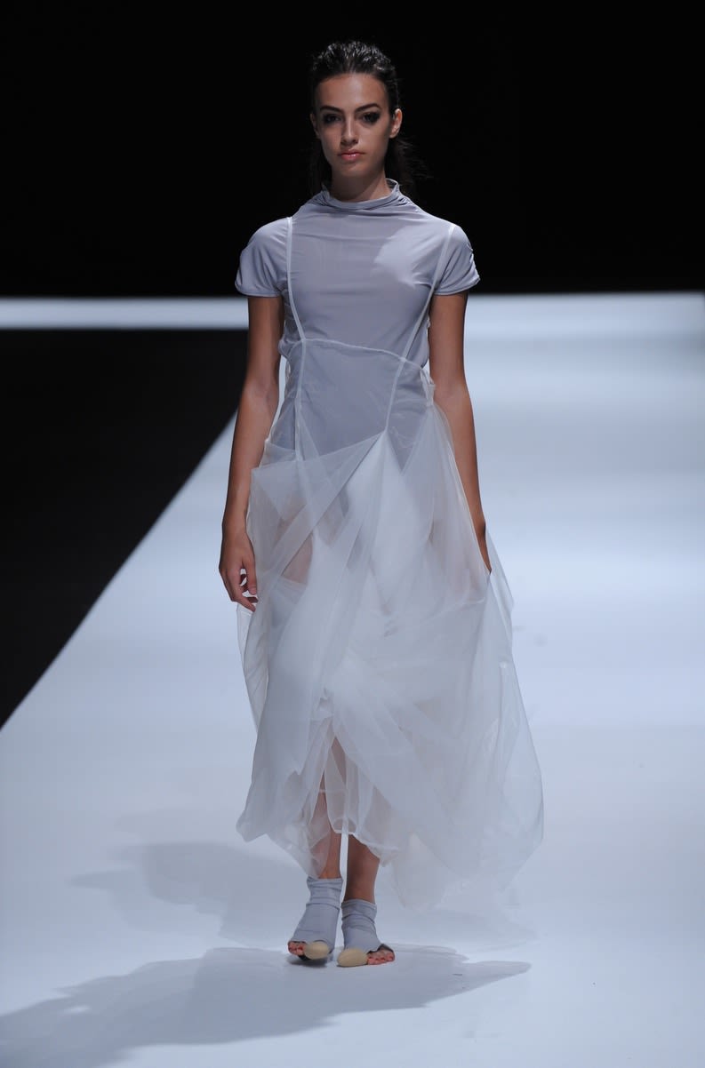Female model wearing grey dress designed by Mengqi Lin
