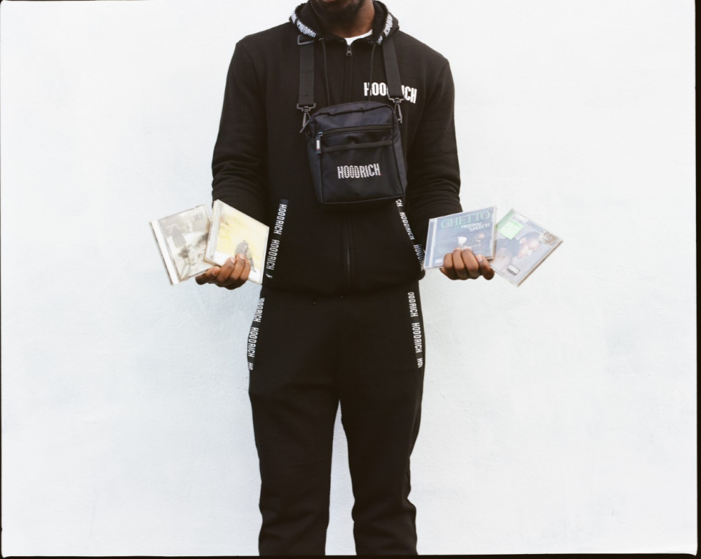 Shot of a young man holding 4 Grime music CDs