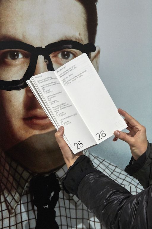 Image of gallery catalogue next to large portrait