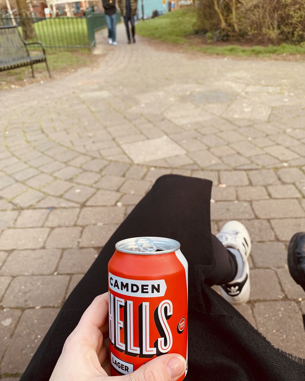 someone drinking beer in park alone