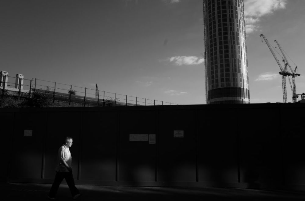 a man walking with industrial background