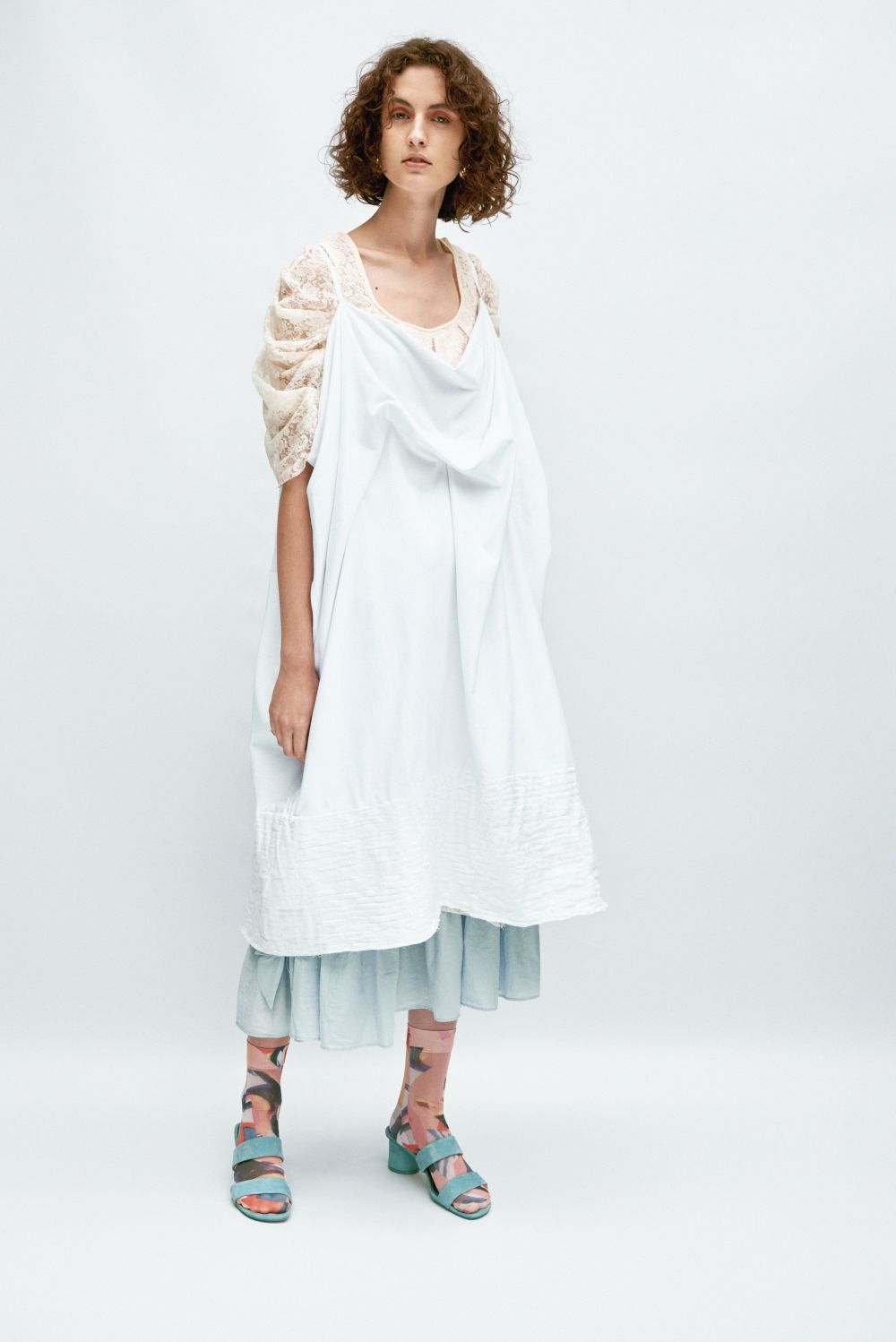 model in white loose dress garment