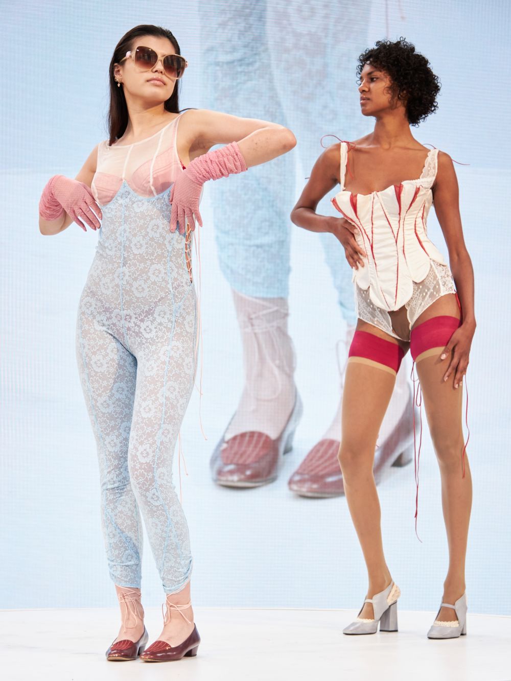 Models on rotating platform wearing lingerie