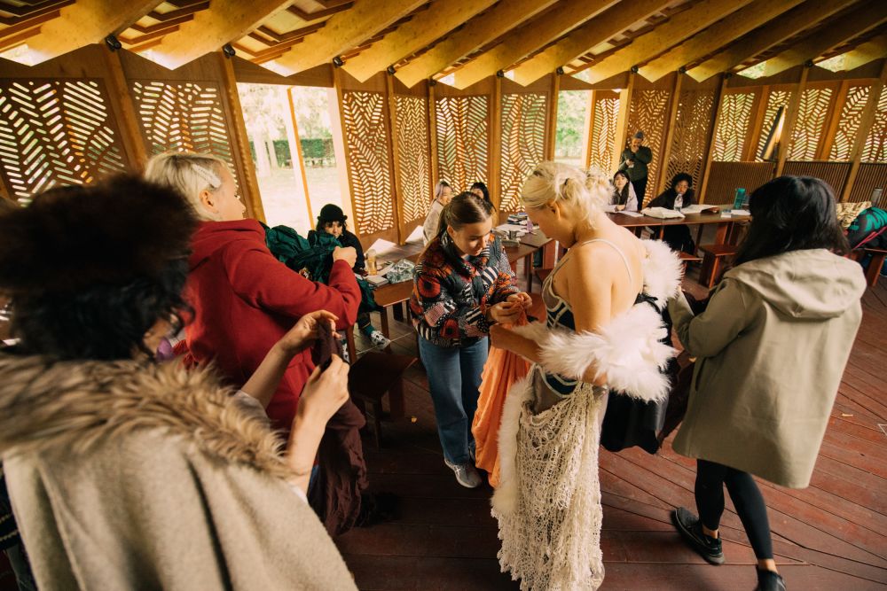 Students draping materials over model