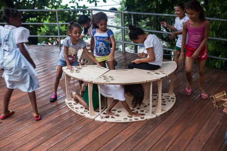Children playing on a wooden structure 