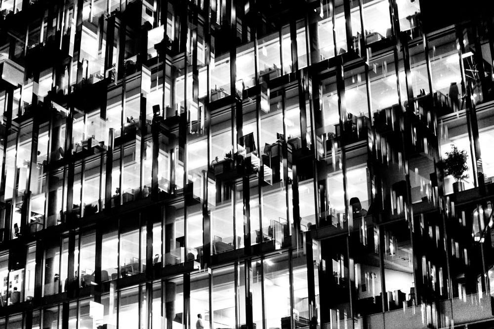Blurry abstract black and white photo of external glass windows on tower block.