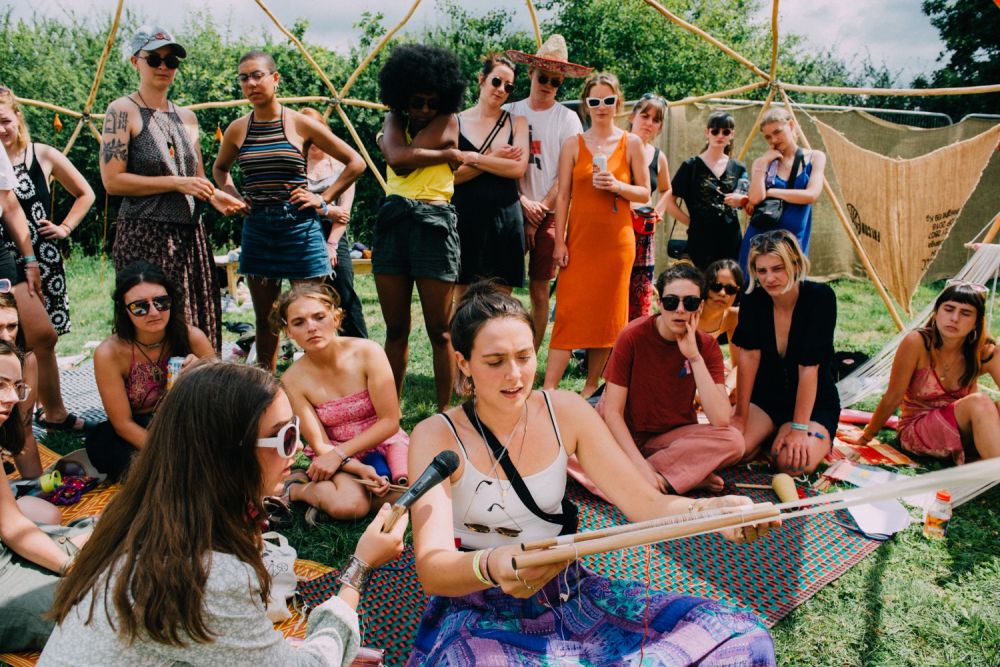 Busy workspace full of people learning to weave
