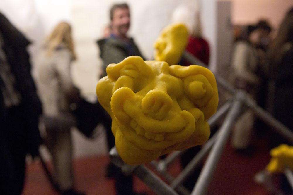 Detail of a sculpture with distored yellow face