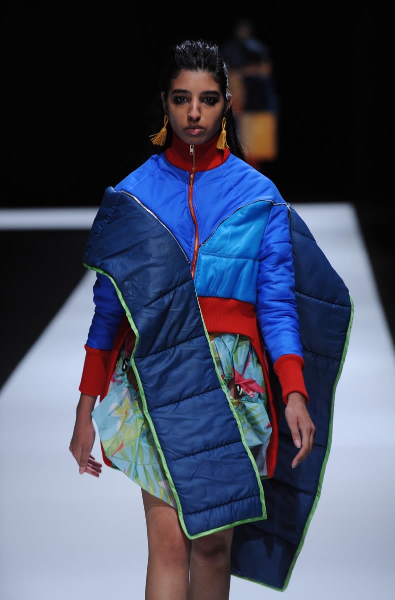 Female model wearing colourful dress made out of sleeping bags designed by Amber Kim