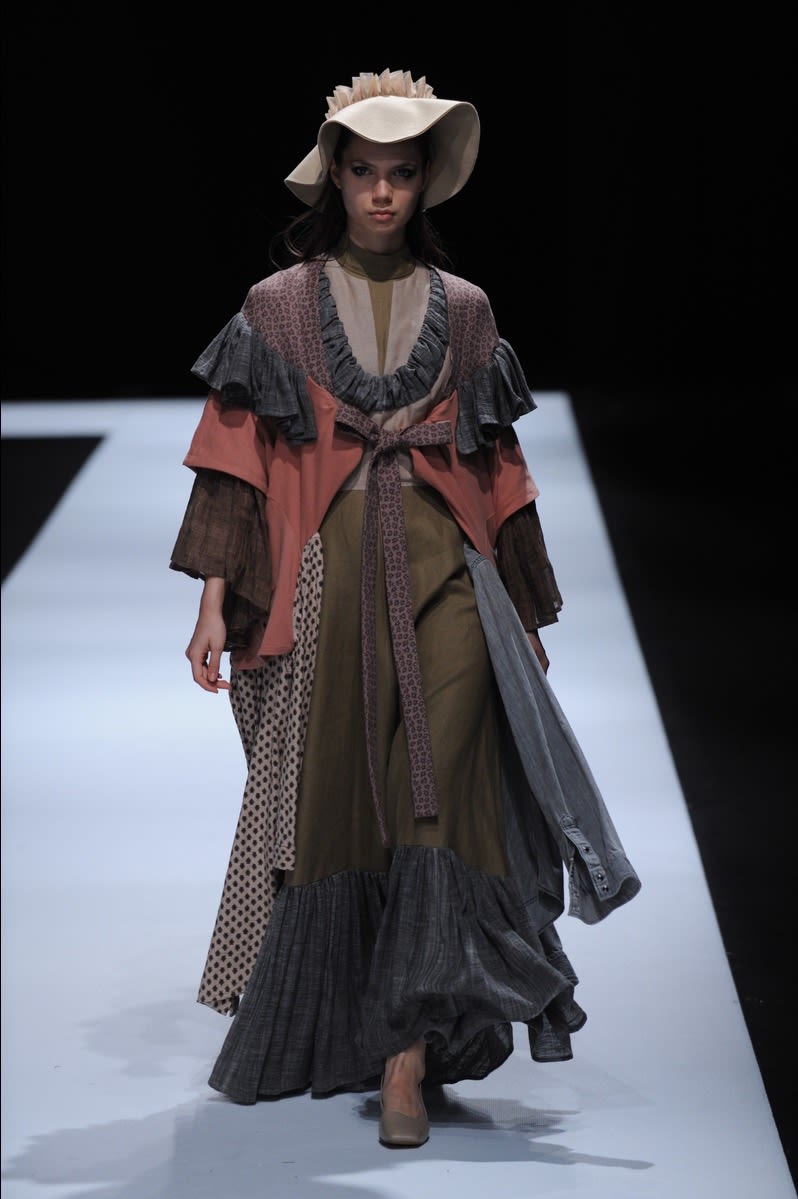 Female model wearing a multi-piece dress designed by Yilan Jia