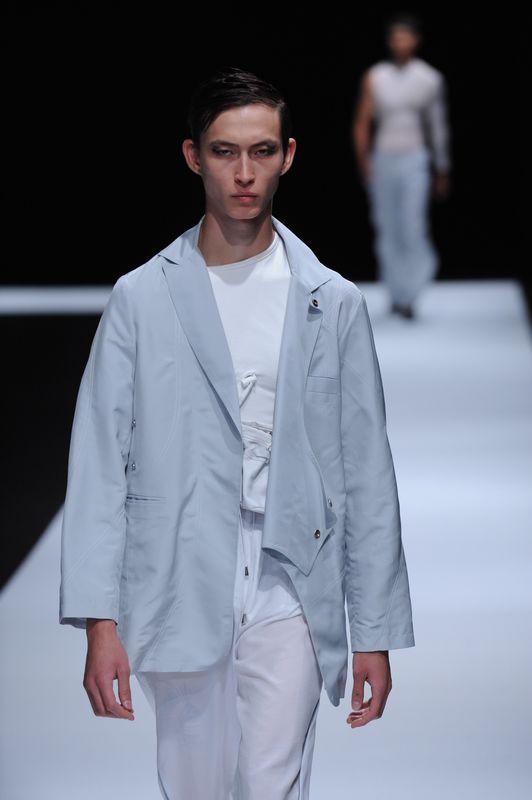 Male model with white clothing and powder blue jacket