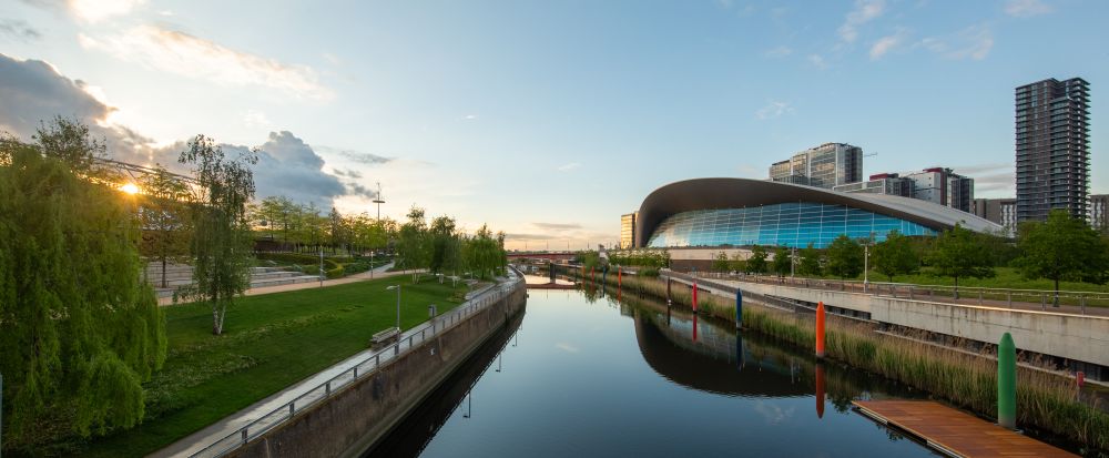a sunset view of London Aquatics Center from the canal