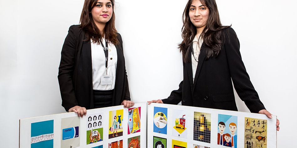 Two ladies pose with examples of ladybird book covers