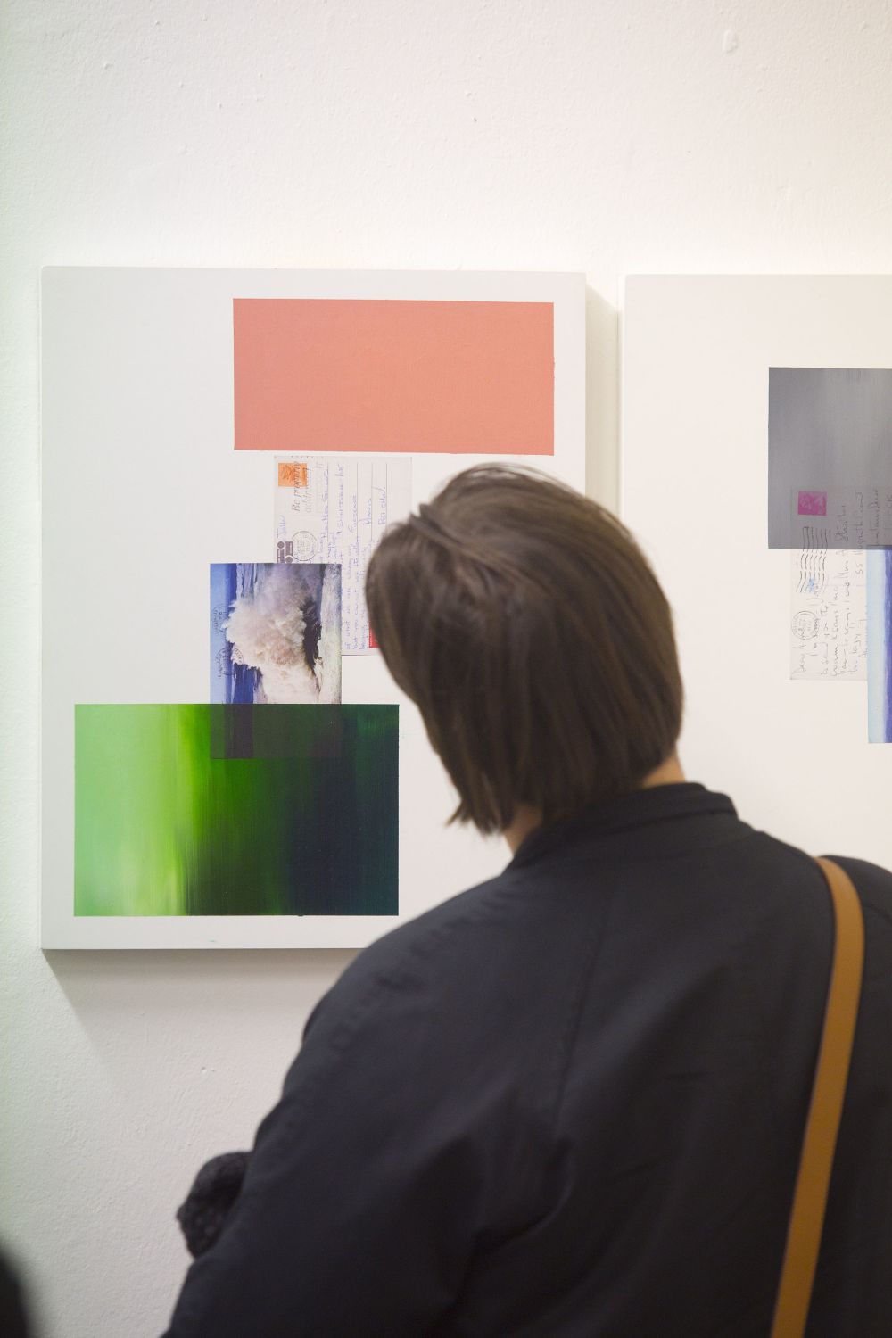 Person looking at green and pink painting