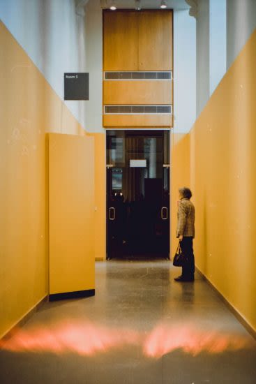 Corridor with woman stood at the end
