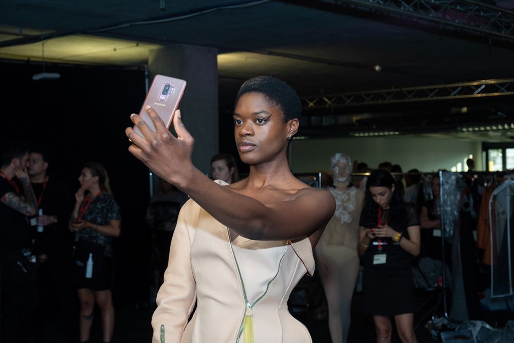 Model taking a selfie backstage