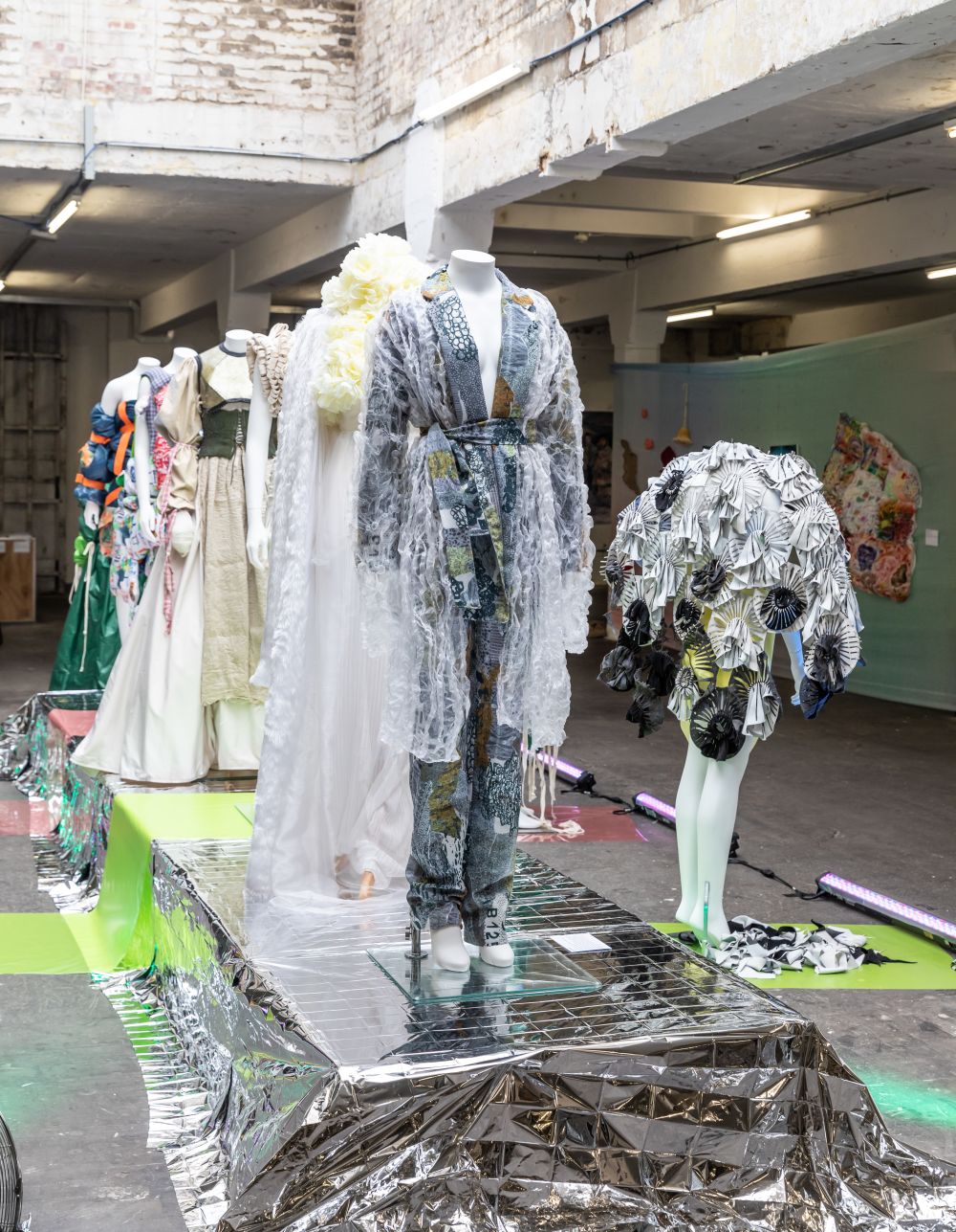 A catwalk with mannequins wearing garments design by UAL Awarding Body students
