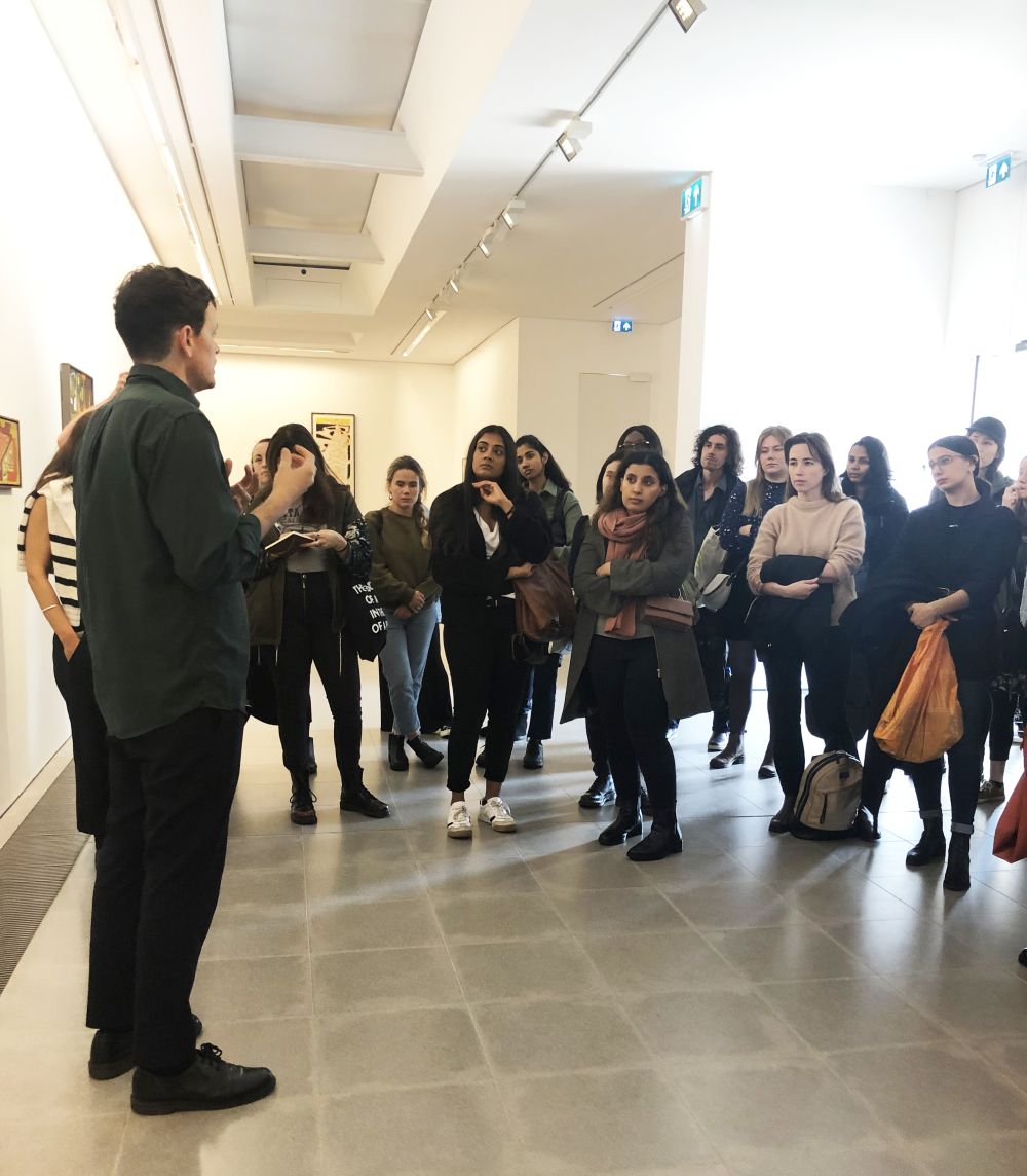 Image of curator talking to students in gallery space
