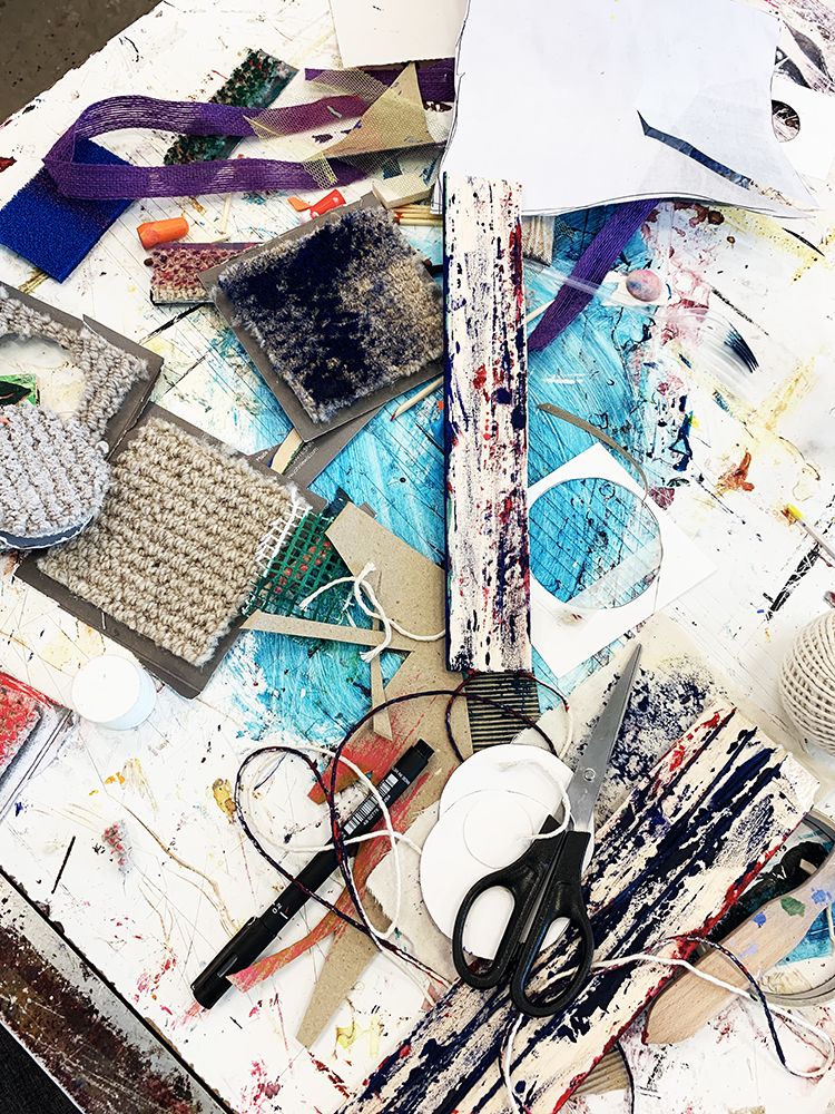 Textile design materials and equipment on table in the textile design studio.