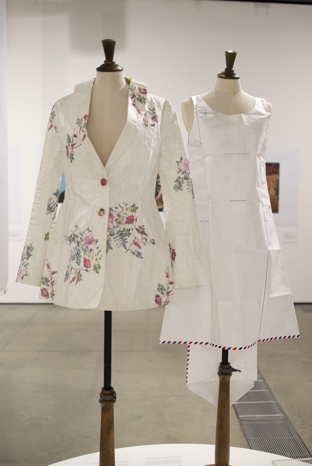 Two paper garments arranged on mannequins