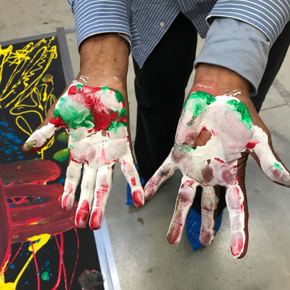 Hands covered with paint