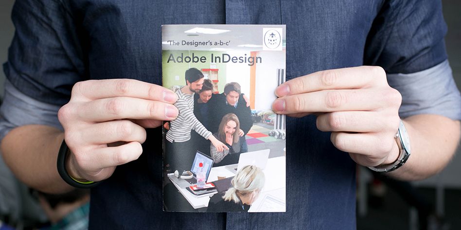 A man holds 'the Designers a-b-c' a guide to Adobe Indesign