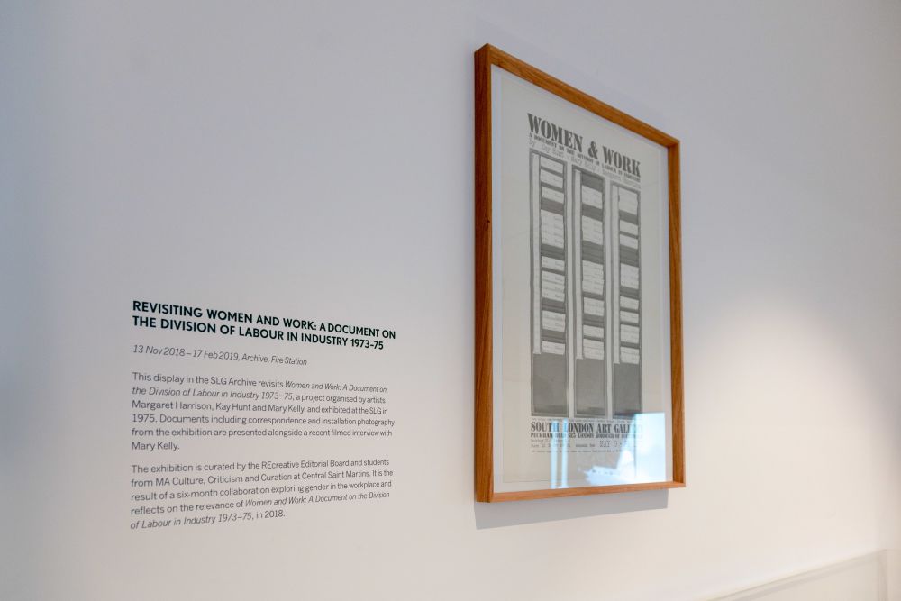 A framed document next to an extract about the exhibition Revisiting Women and Work