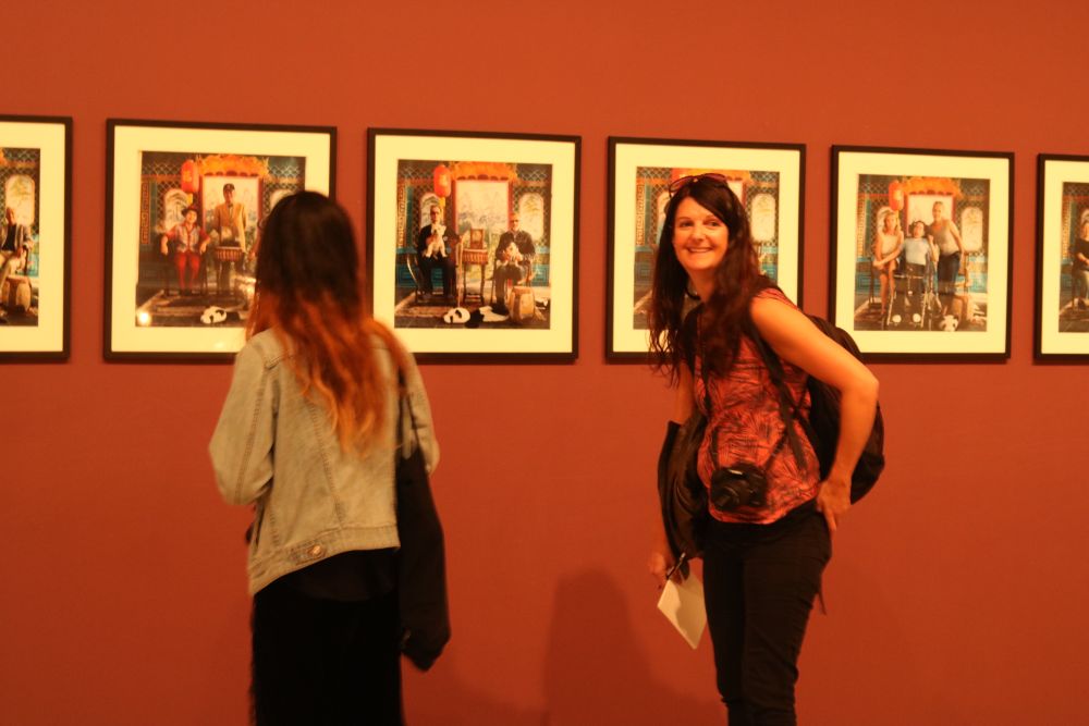 Two women looking at a set of photographs in the Turner gallery