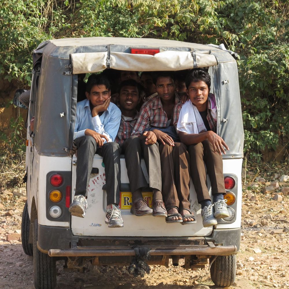 photo of kids in Asia on the back of a truck