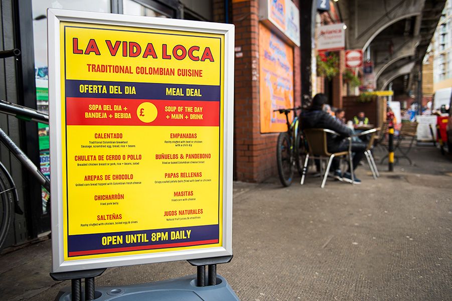 New pavement sign with menu and logo designed by Lauren Vaughan for La Vida Loca Colombian restaurant located in the arches at Elephant Rd.