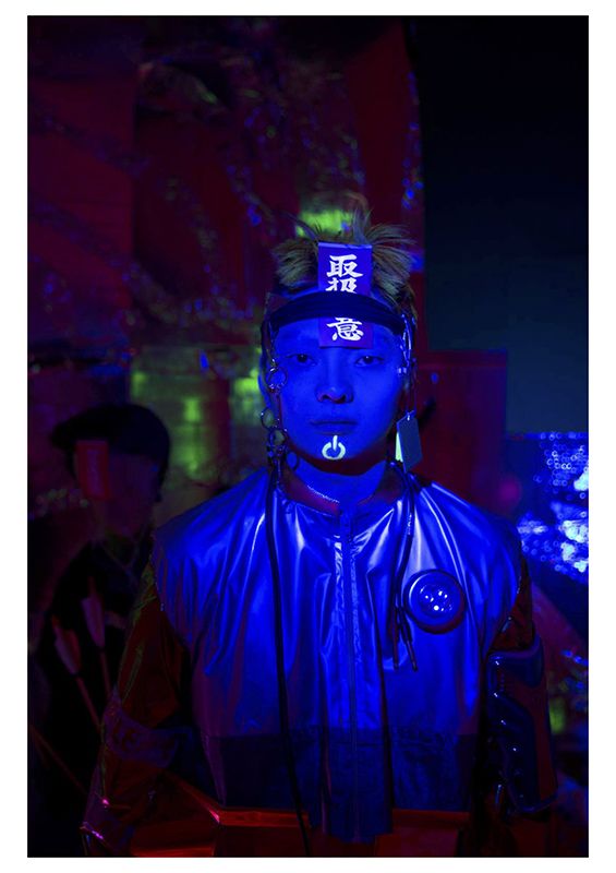 Male model standing in the dark with a blue light