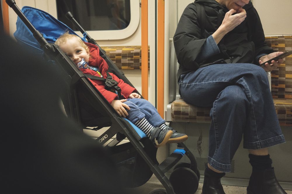 child on tube in buggy smiling