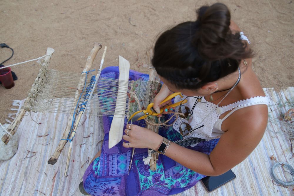 Women weaving outdoor using handloom