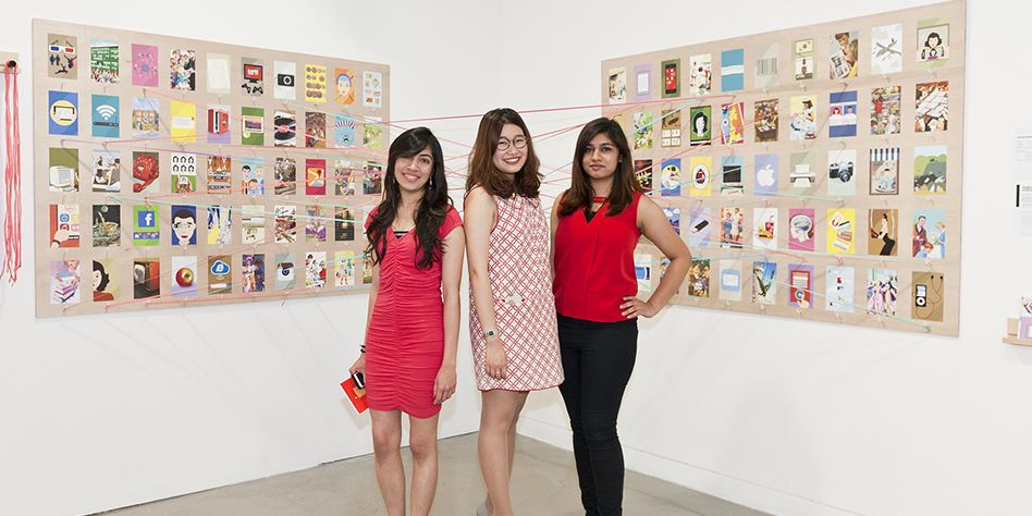 three ladies stand proudly in front of examples of ladybird covers